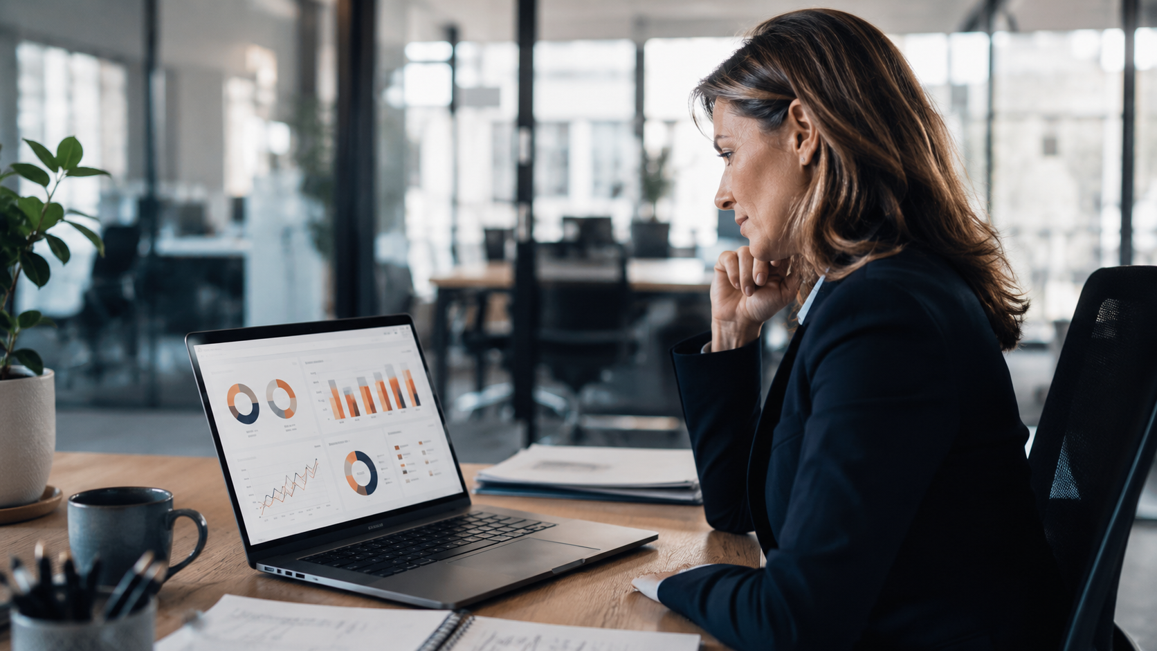 HR and finance professional reviewing Workday workforce and financial data on a laptop